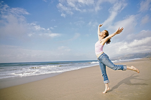 young-woman-beach-waves-dancing-joy-healthy-supple-flexible